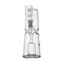 The MJ Arsenal Turret Mini Dab Rig is a clear borosilicate glass piece with a cylindrical base, intricate glasswork, and a metal joint. Its portable design features multiple connecting tubes, ideal for vaporizing concentrates.