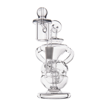 The MJ Arsenal Infinity Mini Dab Rig is made of clear borosilicate glass with a round base, curved body, cylindrical chamber, intricate glass parts, and gray joint fitting—perfect for dabbing in a compact design.