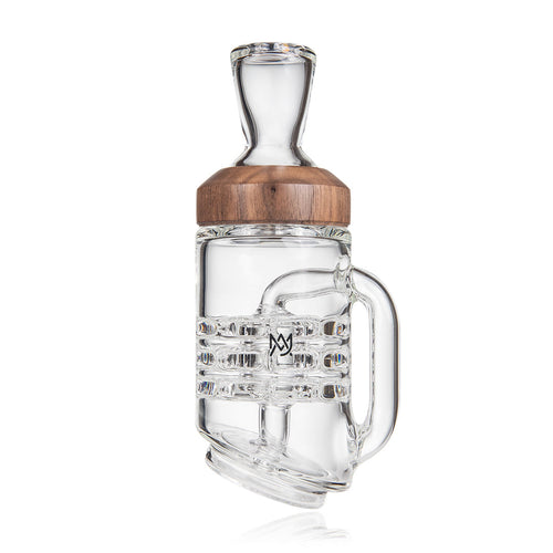 The MJ Arsenal Alpine Series - Halo Peak Top is a clear borosilicate glass mug-inspired water pipe featuring internal percolation, a wood accent around the neck, a side handle, and a front logo—perfect for elevating your setup. Shown on a white background.