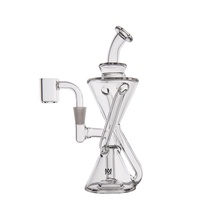 The MJ Arsenal Time Turner Mini Dab Rig, made from clear borosilicate glass with an hourglass body, angled mouthpiece, side percolator, and flat base, is shown against a white background.