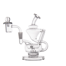 The MJ Arsenal Claude Mini Dab Rig, made of clear glass, features multiple chambers, a side arm, and a dome-shaped mouthpiece, shown against a plain white background.