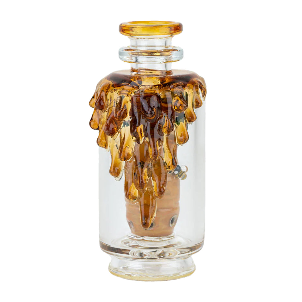 The Empire Glass Works Save the Bees Peak Top is a clear borosilicate glass bottle with a neck and rim, adorned with golden-brown drips from the top, resembling melted honey—a stunning handcrafted art piece.
