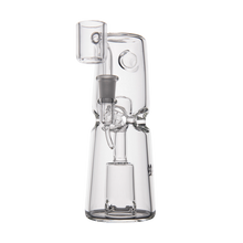 The MJ Arsenal Turret Mini Dab Rig is a clear borosilicate glass dab rig with a sturdy base, cylindrical design, and built-in bowl and downstem—ideal as a durable, portable option for vaporizing concentrates on the go.
