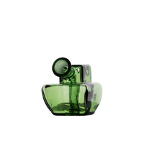 The MJ Arsenal Commander Blunt Bubbler is a modern, green glass piece made from borosilicate glass, featuring an asymmetrical shape and a tilted, cylindrical neck, evoking the look of a mini bubbler against a plain white background.