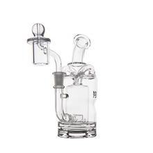 The MJ Arsenal Turbine Mini Dab Rig, made of durable borosilicate glass, features a cylindrical base, curved mouthpiece, and Inception Turbine Perc chamber. It is displayed against a plain white background.