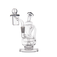 The MJ Arsenal Claude Mini Dab Rig is a clear glass recycler with a round base, curved neck, and attached bowl, designed for filtration and smoking, shown against a plain white background.