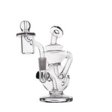 The MJ Arsenal Mini Jig Mini Dab Rig, crafted from clear glass with twisted tubing, a wide base, cylindrical chamber, and a glass handle with cap, is shown against a plain white background.