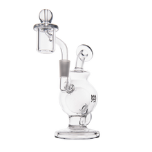 The MJ Arsenal Atlas Mini Dab Rig is a clear borosilicate glass piece with a rounded base, angled neck, cylindrical chamber, detachable glass carb cap, and banger—displayed against a plain white background.