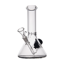 The MJ Arsenal Cache Bong is a clear mini borosilicate glass beaker with a cylindrical neck and removable bowl, shown empty against a white background.