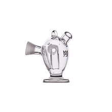 The MJ Arsenal Dubbler Original Double Bubbler is a clear borosilicate glass adapter with a rounded body, wide base, two angled top openings, side spout, and black “MV” logo—ideal for smooth water filtration. Shown on a plain white background.