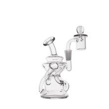 The MJ Arsenal Hydra Mini Dab Rig is a clear glass rig with a curved mouthpiece, compact Klein recycler design, and attached quartz banger, shown on a plain white background.