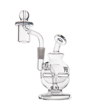 The MJ Arsenal Royale Mini Dab Rig is a clear borosilicate glass piece with a rounded base, angled neck, attached banger, intricate internal tubing, and a small logo on the side. It sits against a plain white background.