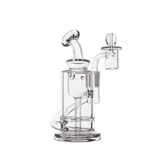 The MJ Arsenal Ursa Mini Dab Rig is a clear borosilicate glass piece featuring a cylindrical base, angled mouthpiece, and bowl attachment for concentrates, shown against a white background.