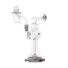 The MJ Arsenal Apollo Mini Dab Rig is a clear borosilicate glass water pipe featuring a wide base, curved neck, side mouthpiece, and removable top bowl for optimal flavor preservation, displayed against a plain white background.