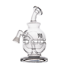 The MJ Arsenal Royale Vape Edition is a clear glass dab rig featuring a round chamber, angled neck, side bowl attachment, stylized black logo on the front, and a sturdy circular base.