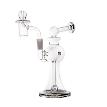 The MJ Arsenal Apollo Mini Dab Rig is a clear borosilicate glass piece with a round base, angled mouthpiece, and side chamber for enhanced flavor. Displayed clean and empty on a white background.