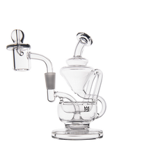 The MJ Arsenal Claude Mini Dab Rig is a clear glass recycler with multiple chambers, a curved mouthpiece, dome-shaped base, and detachable bowl, displayed on a plain white background.