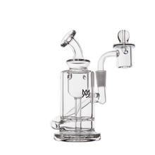 The MJ Arsenal Ursa Mini Dab Rig is made from durable borosilicate glass, with a cylindrical chamber, bent mouthpiece, attached banger, sturdy base, and subtle black logo detailing. Displayed on a white background.