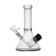 The MJ Arsenal Cache Bong is a clear borosilicate glass beaker with a straight neck, angled bowl, and removable downstem, shown against a plain white background.