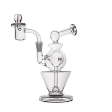 The MJ Arsenal Gemini Mini Dab Rig is a portable clear borosilicate glass water pipe with a unique artistic design, multiple chambers, a curved mouthpiece, an attached bowl, and sits securely on a sturdy base.