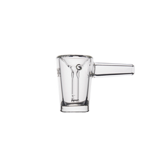 The MJ Arsenal Basin Bubbler is made from clear borosilicate glass with a short cylindrical handle, measurement markings, and a small pouring spout. Shown on a white background, this durable piece utilizes material commonly found in mini bubblers.