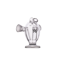 The MJ Arsenal Dubbler Original Double Bubbler is a clear borosilicate glass piece with a round, bulbous body, short angled spout, handle-like loop on top, stable base, and an etched logo on the front for style.