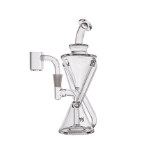 The MJ Arsenal Time Turner Mini Dab Rig, featuring clear borosilicate glass, an hourglass-shaped body, angled mouthpiece, and side-mounted banger attachment, is shown against a plain white background.