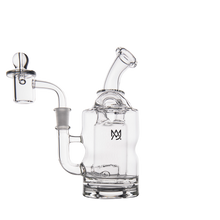The MJ Arsenal Turbine Mini Dab Rig is made of clear borosilicate glass with a rounded chamber, bent neck, and sidearm attached to a domed quartz banger. The Mason logo decorates the chamber on a plain white background.