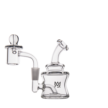 The MJ Arsenal Jammer Mini Dab Rig, made of clear borosilicate glass, features a bent neck, attached banger, and the MJ Arsenal logo on its base. This compact rig is displayed against a white background.