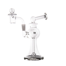 The MJ Arsenal Apollo Mini Dab Rig features clear borosilicate glass, a round base, angled mouthpiece, detachable bowl, and front logo for smooth vapor cooling—shown against a plain white background.