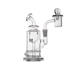 The MJ Arsenal Ursa Mini Dab Rig features clear borosilicate glass, a bent neck, cylindrical chamber with side percolator, attached quartz banger, and a glass logo on the chamber. It is photographed against a plain white background.