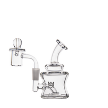 The MJ Arsenal Jammer Mini Dab Rig is a clear borosilicate glass water pipe with a bent mouthpiece, cylindrical base, attached bowl, and crown logo. Its modern, minimalist design makes it portable and stylish.