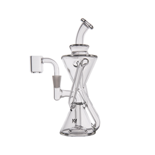 The MJ Arsenal Time Turner Mini Dab Rig is a clear borosilicate glass rig with multiple chambers, a bent neck, side bowl attachment, and upright flat base, featuring an intricate angled design in a compact form.