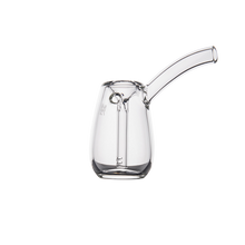 The MJ Arsenal Bulb Bubbler is a clear borosilicate glass vessel with a cylindrical body, rounded base, and angled spout, resembling a modern glass watering can. It’s displayed against a white background.