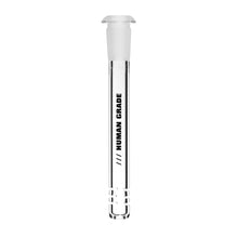 Human Grade Downstems: Clear glass tube with a frosted stopper and three horizontal slots near the base. "HUMAN GRADE" is printed vertically along the side, making it ideal as a water pipe replacement.