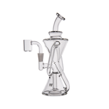 The MJ Arsenal Time Turner Mini Dab Rig is a clear borosilicate glass piece with a geometric design, featuring a conical base, angled neck, and an attached side chamber for enhanced filtration.
