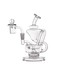 The MJ Arsenal Claude Mini Dab Rig is a clear glass recycler rig with a wide base, angled mouthpiece, attached quartz banger, and glass carb cap. Its intricate looping design stands out against a plain white background.