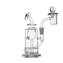 The MJ Arsenal Ursa Mini Dab Rig is a clear borosilicate glass piece with a cylindrical base, angled mouthpiece, quartz banger, and small black logo on the chamber, shown on a white background.