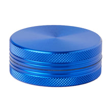 The 2 Piece Flat Grinder is a round, blue metal grinder with a textured grip and two visible sections, displayed against a white background. It comes in multiple colors and size options.