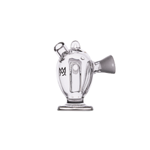 The MJ Arsenal Dubbler Original Double Bubbler features clear borosilicate glass, a rounded body, flared base, angled mouthpiece, and small handle—perfect for smooth water filtration—displayed on a plain white background.
