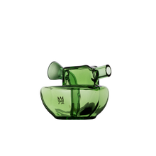 The MJ Arsenal Commander Blunt Bubbler is a modern green borosilicate glass piece with a round base, side spout, and circular handle, cone bubbler-inspired, featuring a small abstract logo on the front, shown on a plain white background.