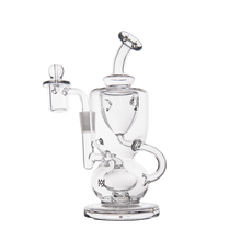 The MJ Arsenal Titan Mini Dab Rig, made from clear borosilicate glass with a curved mouthpiece, round base, side arm for a banger, and glass carb cap, is displayed against a plain white background.