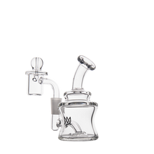 The MJ Arsenal Jammer Mini Dab Rig is a clear borosilicate glass piece with a modern, compact design, featuring a curved mouthpiece, cylindrical chamber, and attached bowl. It’s showcased on a plain white background.