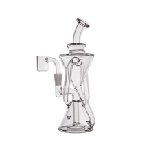 The MJ Arsenal Time Turner Mini Dab Rig features clear borosilicate glass, a unique hourglass-shaped chamber, angled mouthpiece, and a left-side attached quartz banger. This compact rig stands out against a plain white background.