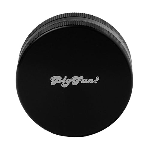 A black, round aluminum BIGFUN! Medium 2pc Grinder lid with ridged edges and 