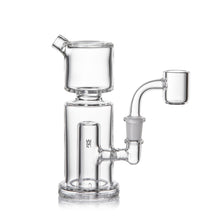 The MJ Arsenal Column Mini Dab Rig is made from durable borosilicate glass and features a cylindrical chamber, bent neck, wide base, and 10mm quartz banger. It’s showcased on a white background.