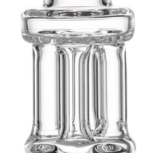 Close-up of the MJ Arsenal Tetra, a clear, thick borosilicate glass hand pipe with vertical ridges and smooth, rounded edges, featuring reflections and highlights on its transparent surface.