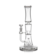 The MJ Arsenal Spire Glass Water Pipe is a clear borosilicate bong with a cylindrical neck, wide base, and side 14mm flower bowl attachment, shown upright on a white background.
