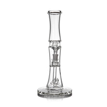 The MJ Arsenal Spire Glass Water Pipe is a clear borosilicate piece with a cylindrical neck, intricate central chamber, sturdy round base, and 14mm flower bowl, shown against a plain white background.