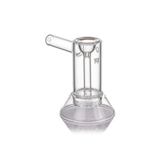 The MJ Arsenal Cove Glass Bubbler is made from clear borosilicate glass and features a cylindrical chamber, angled mouthpiece, wide base, minimalist design, and a small etched logo on the side.